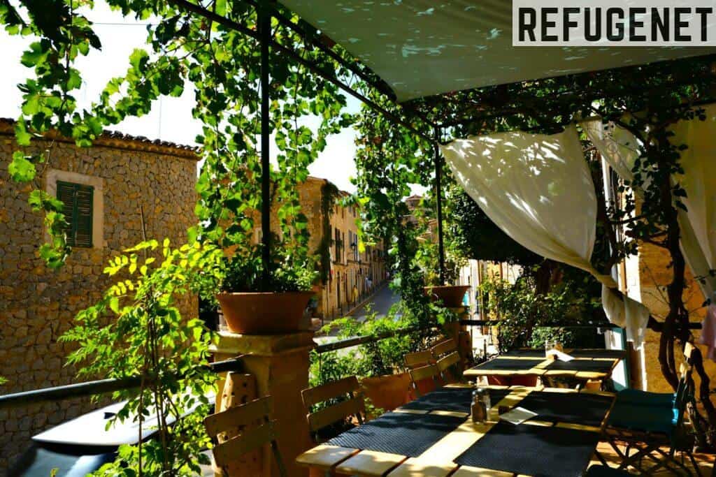 a patio with tables and chairs